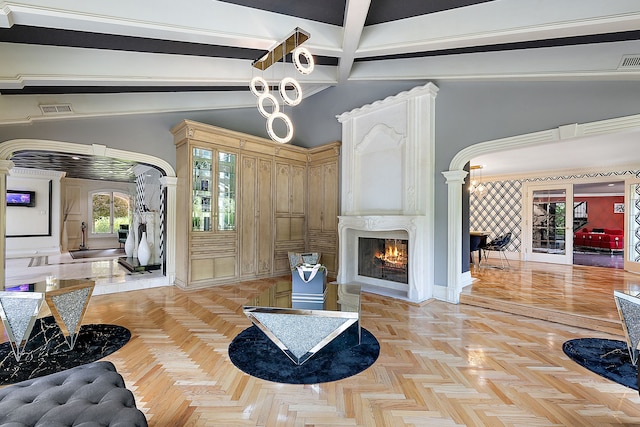 living room with vaulted ceiling with beams, a fireplace, and light parquet floors