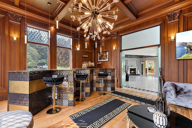 bar featuring coffered ceiling, wooden walls, hardwood / wood-style flooring, ornamental molding, and beam ceiling