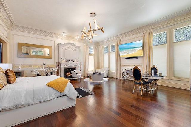 bedroom featuring a chandelier, crown molding, and dark wood-type flooring