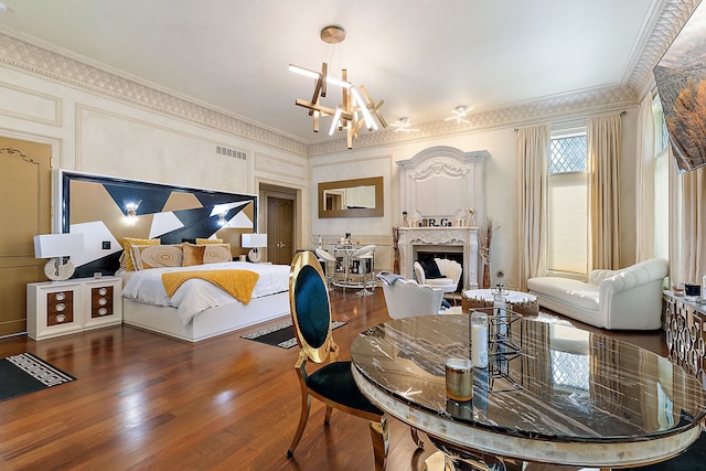 bedroom with a chandelier, hardwood / wood-style floors, and ornamental molding