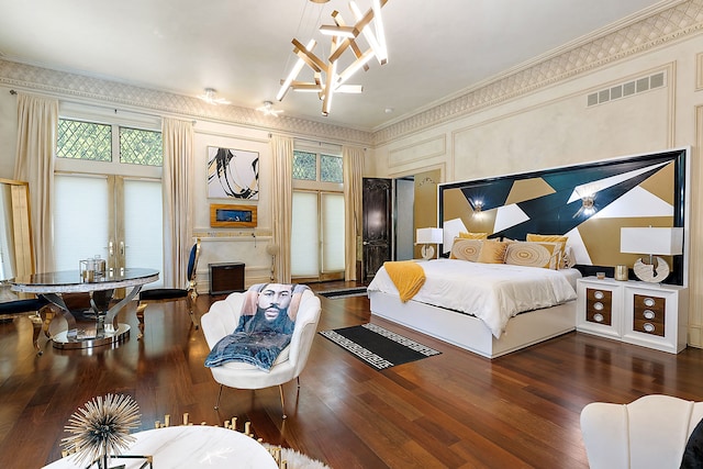 bedroom with dark hardwood / wood-style floors, multiple windows, and ornamental molding