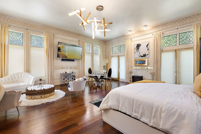 bedroom featuring a chandelier, crown molding, and dark wood-type flooring