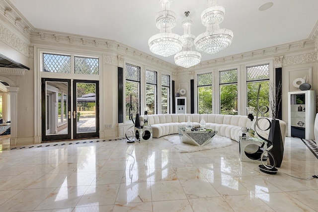 living room with crown molding and a chandelier