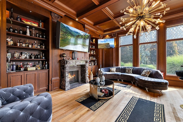 interior space featuring coffered ceiling, beam ceiling, an inviting chandelier, wooden ceiling, and a premium fireplace