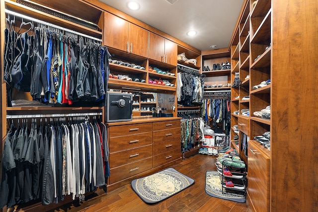 spacious closet featuring dark hardwood / wood-style floors