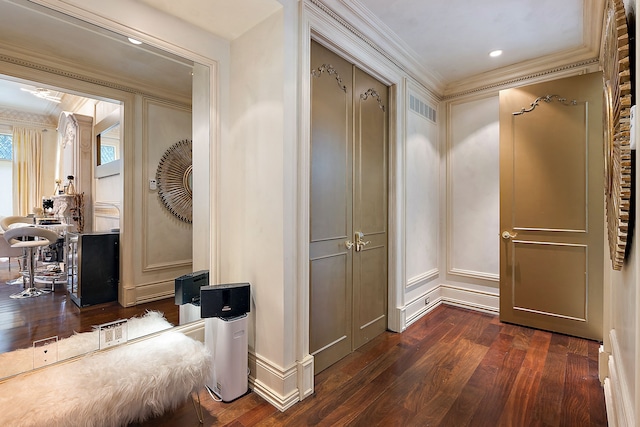 hall with dark hardwood / wood-style floors and ornamental molding