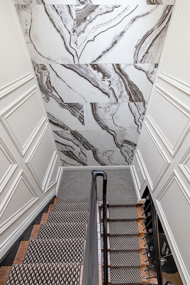 stairway featuring wood-type flooring