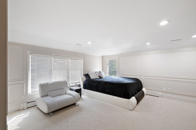 carpeted bedroom with a baseboard radiator