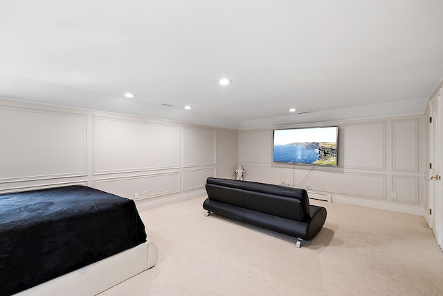 bedroom featuring light colored carpet and a baseboard heating unit