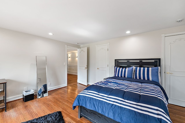 bedroom with hardwood / wood-style flooring