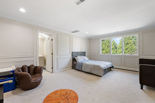 bedroom featuring light carpet, connected bathroom, and crown molding