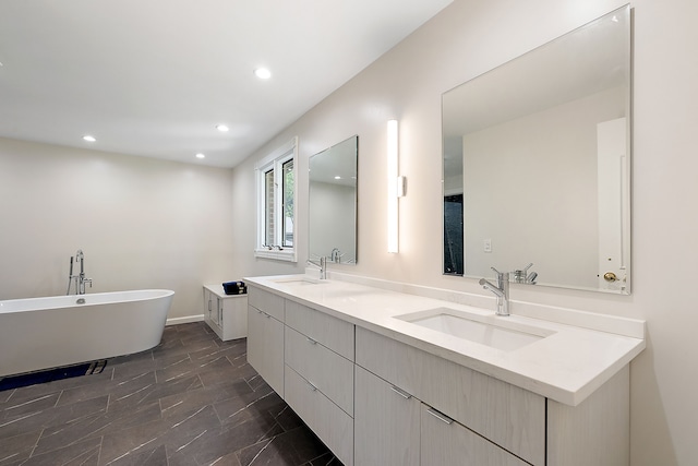 bathroom featuring a bath and vanity