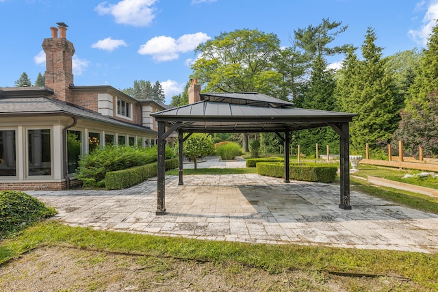 view of property's community with a gazebo and a patio