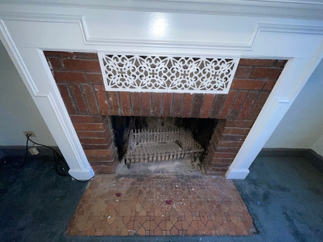 interior details featuring carpet flooring and a brick fireplace