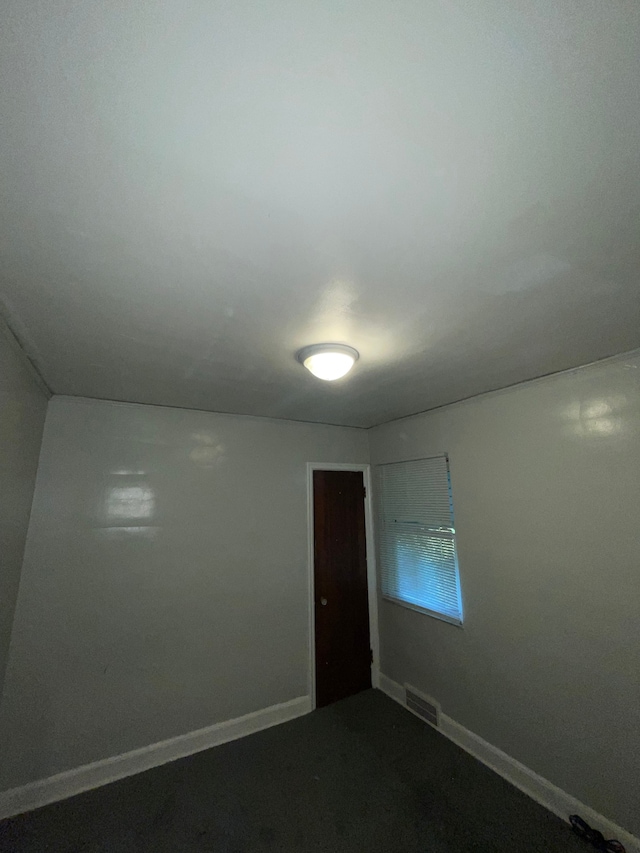 unfurnished room featuring carpet flooring