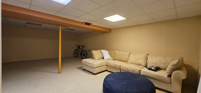 unfurnished living room featuring carpet flooring and a paneled ceiling