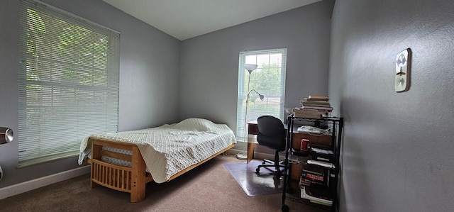 bedroom featuring carpet flooring and vaulted ceiling