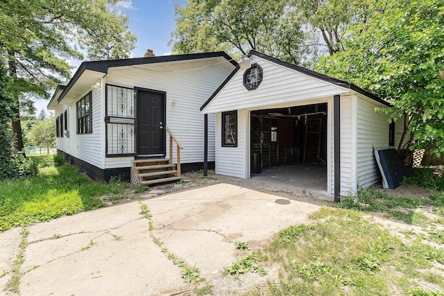 view of front facade featuring a garage and an outdoor structure