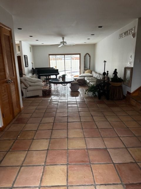 living room featuring a ceiling fan and light tile patterned floors