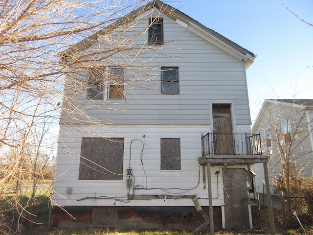 rear view of house featuring a balcony