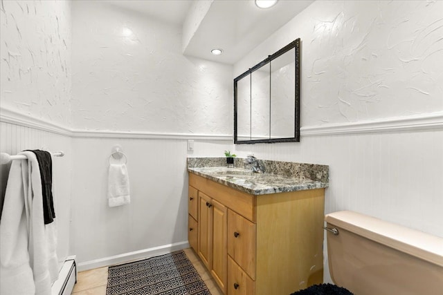 bathroom featuring tile patterned flooring, vanity, toilet, and a baseboard radiator