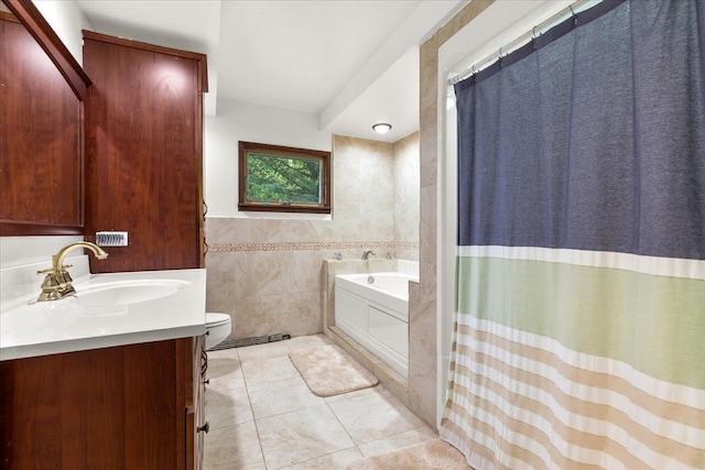 bathroom with tile patterned flooring, a bath, toilet, vanity, and tile walls