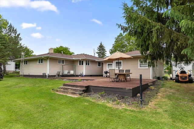 back of house featuring a yard and a deck