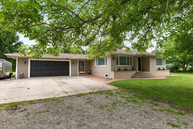 ranch-style home with a front yard and a garage