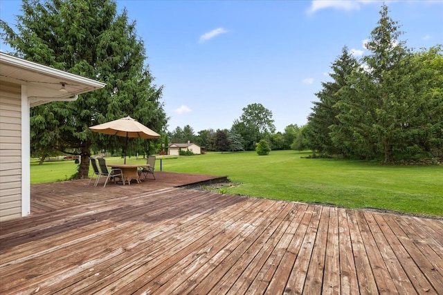 wooden deck featuring a lawn