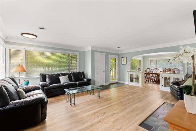 living room with ornamental molding and light hardwood / wood-style flooring