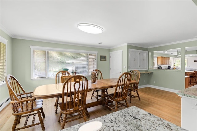 dining area featuring hardwood / wood-style floors and ornamental molding