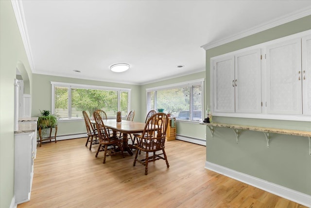 dining area with light wood-type flooring, a baseboard radiator, plenty of natural light, and crown molding