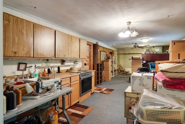 kitchen with light carpet, black range, hanging light fixtures, and ceiling fan with notable chandelier