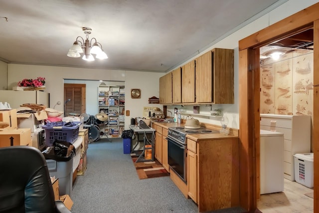 kitchen featuring black stove, crown molding, a chandelier, pendant lighting, and light carpet