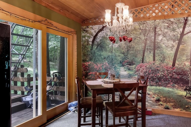 carpeted dining room featuring wooden ceiling and a notable chandelier