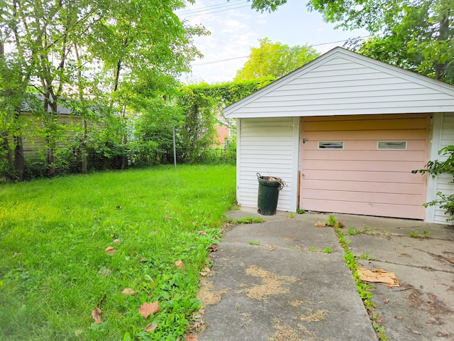 garage featuring a lawn