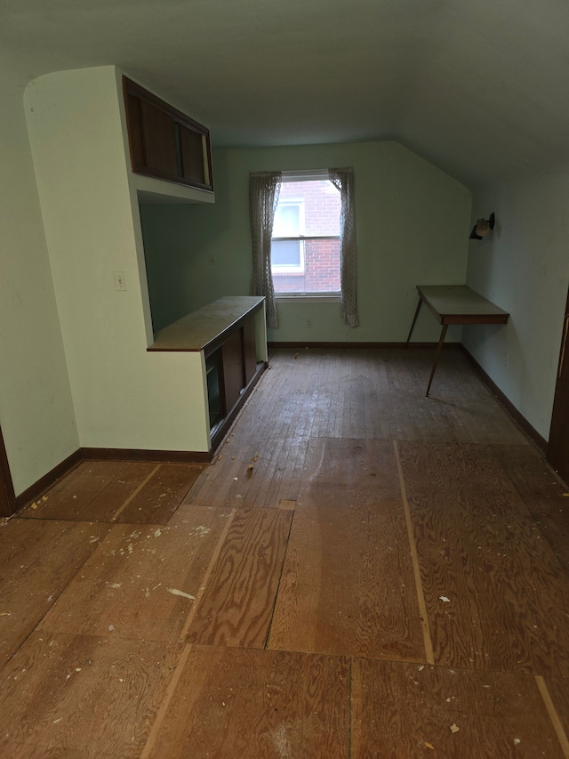 bonus room with dark hardwood / wood-style flooring and lofted ceiling