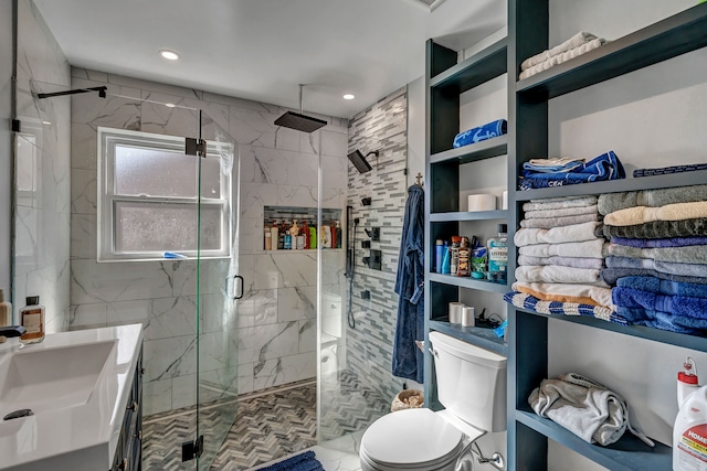 bathroom with vanity, toilet, and a shower with door