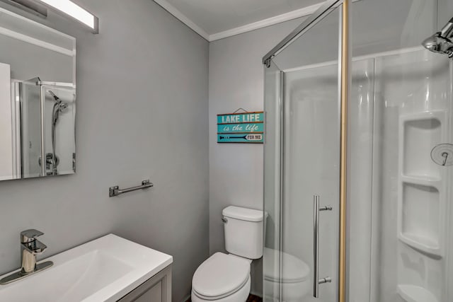 bathroom with vanity, toilet, and a shower with shower door