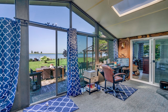 sunroom / solarium featuring a water view and vaulted ceiling