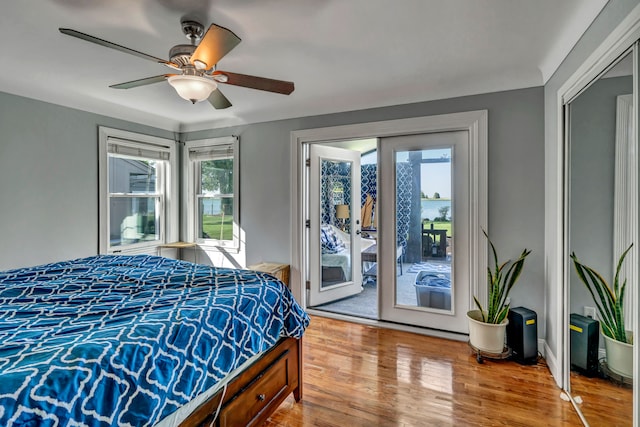 bedroom with hardwood / wood-style floors, ceiling fan, and access to exterior