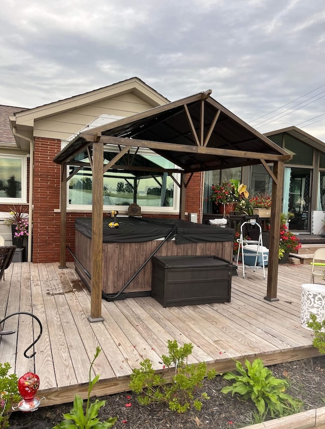 wooden deck with a gazebo and a hot tub