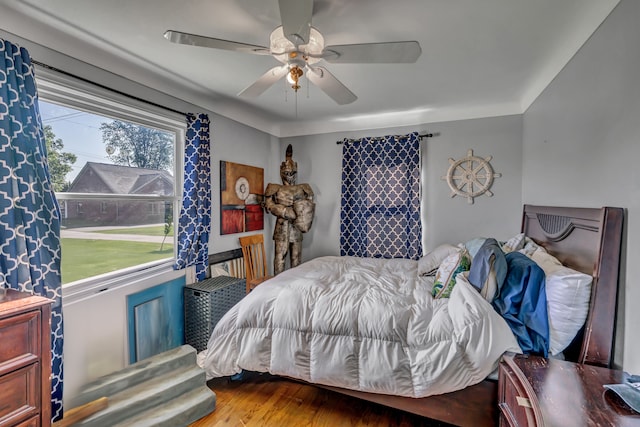 bedroom with ceiling fan and hardwood / wood-style floors