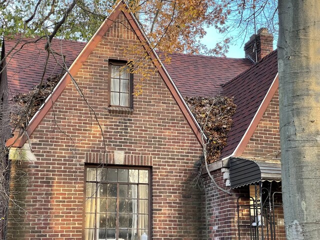 18404 Salem, Detroit, MI 48219 - view of side of property featuring brick siding and a shingled roof