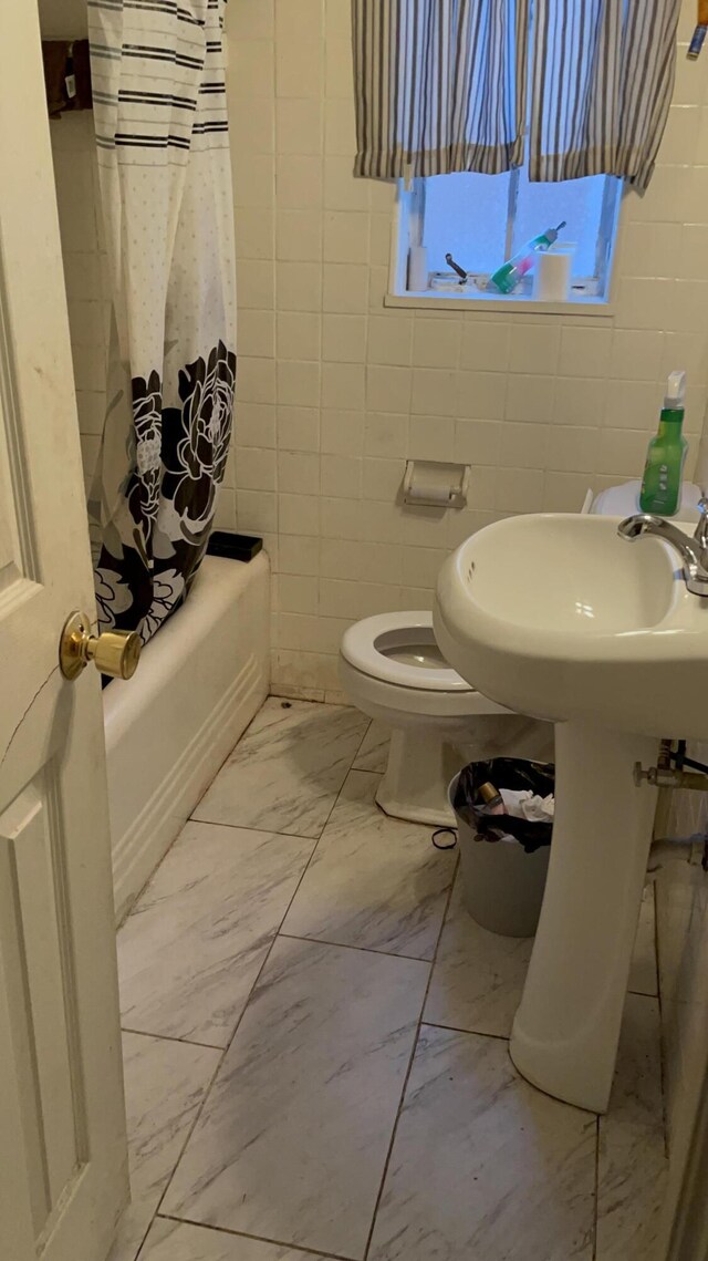 18404 Salem, Detroit, MI 48219 - full bath with marble finish floors, tile walls, toilet, and shower / bathtub combination with curtain