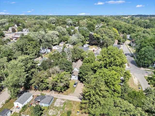 bird's eye view featuring a wooded view and a residential view