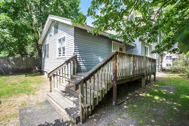 back of house featuring a deck, a yard, and fence