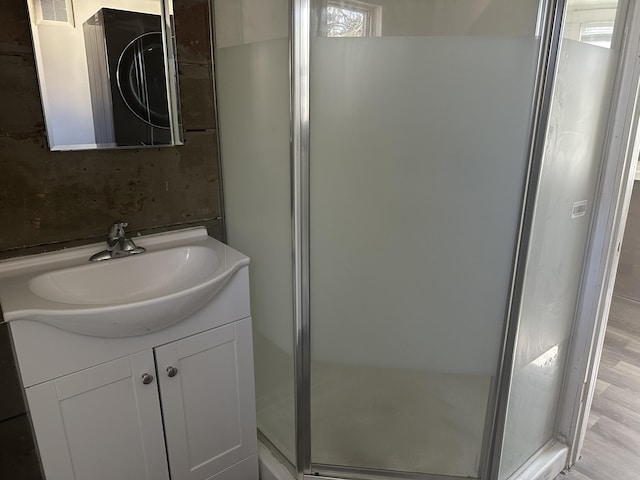 full bathroom featuring visible vents, a shower stall, and vanity