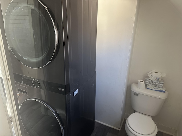 laundry area featuring stacked washer / drying machine