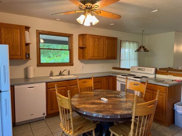 kitchen with ceiling fan, white appliances, sink, and light tile patterned floors